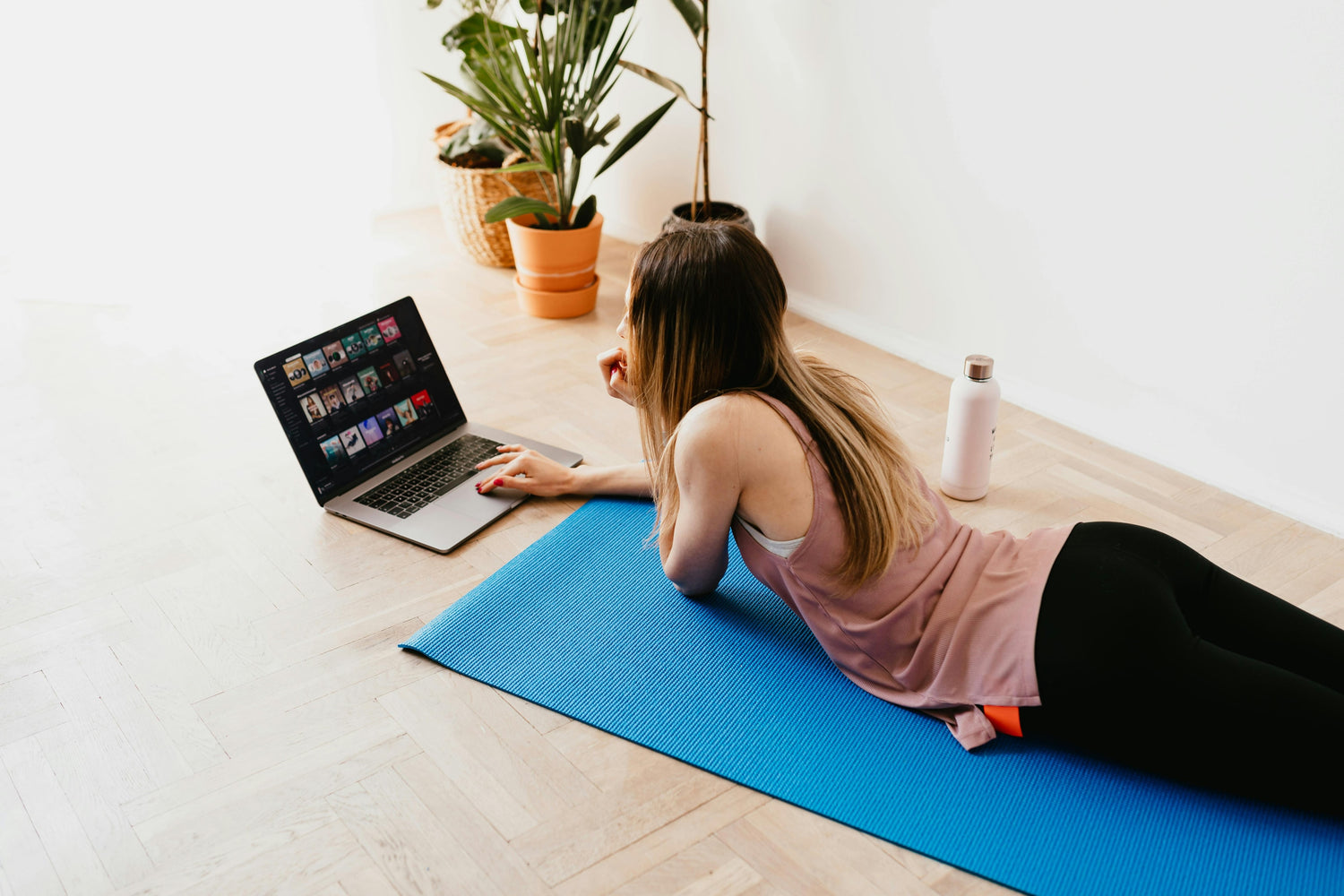 Photo by Photo By: Kaboompics.com: https://www.pexels.com/photo/young-woman-lying-on-floor-on-mat-while-using-laptop-at-home-4498359/