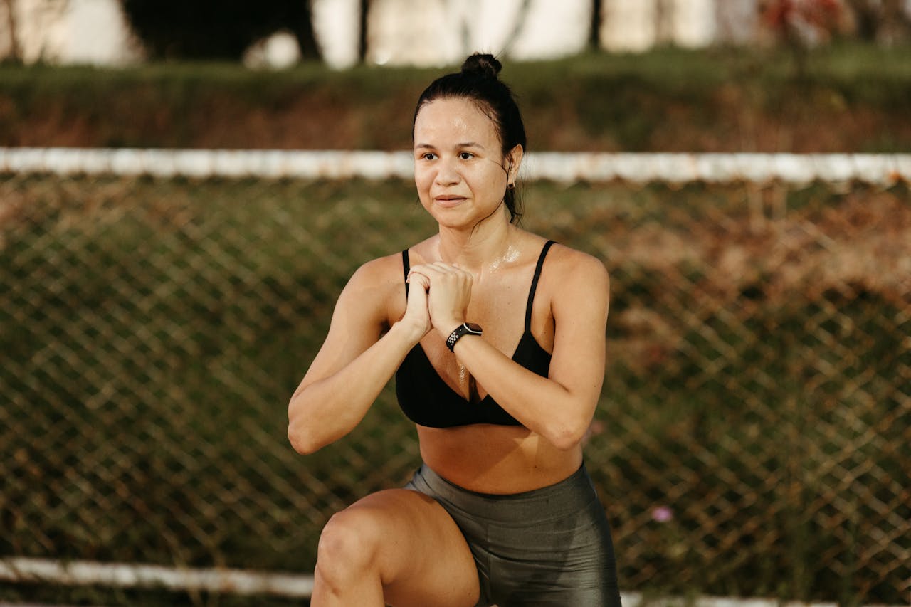 Photo by Jonathan Borba: https://www.pexels.com/photo/a-woman-in-a-sports-bra-squatting-in-front-of-a-fence-15491996/