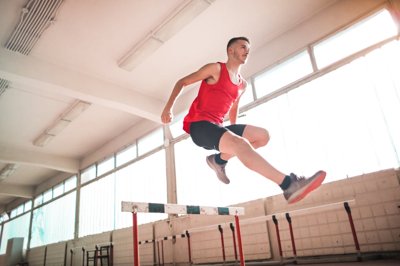 Photo by Andrea Piacquadio: https://www.pexels.com/photo/woman-in-red-tank-top-jumping-on-obstacle-3763879/