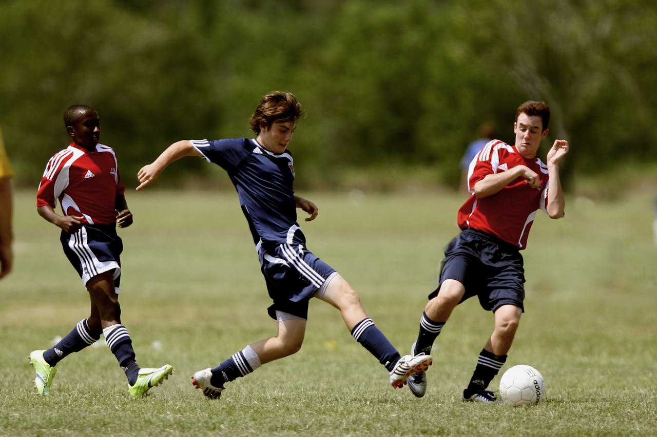 Photo by Pixabay: https://www.pexels.com/photo/three-men-playing-soccer-274422/