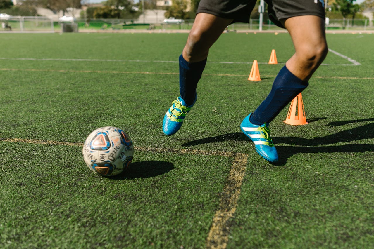 Photo by RDNE Stock project: https://www.pexels.com/photo/man-in-blue-sneakers-playing-football-7188095/