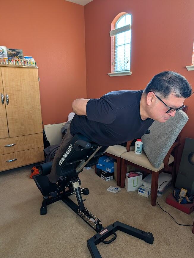 C.R. performing a back extension on the NordBench Pro