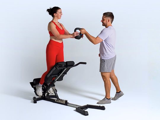 Garrett assisting an athlete on a NordBench